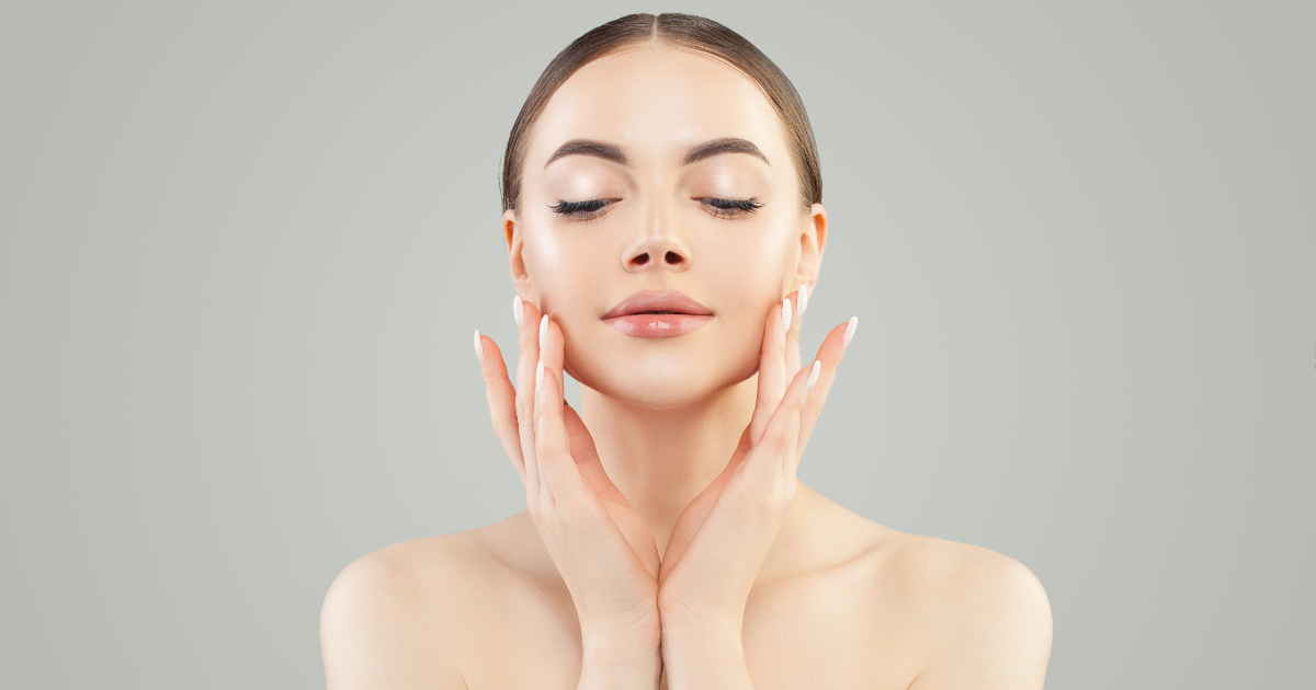 Woman holding her beautiful face with her two hands.